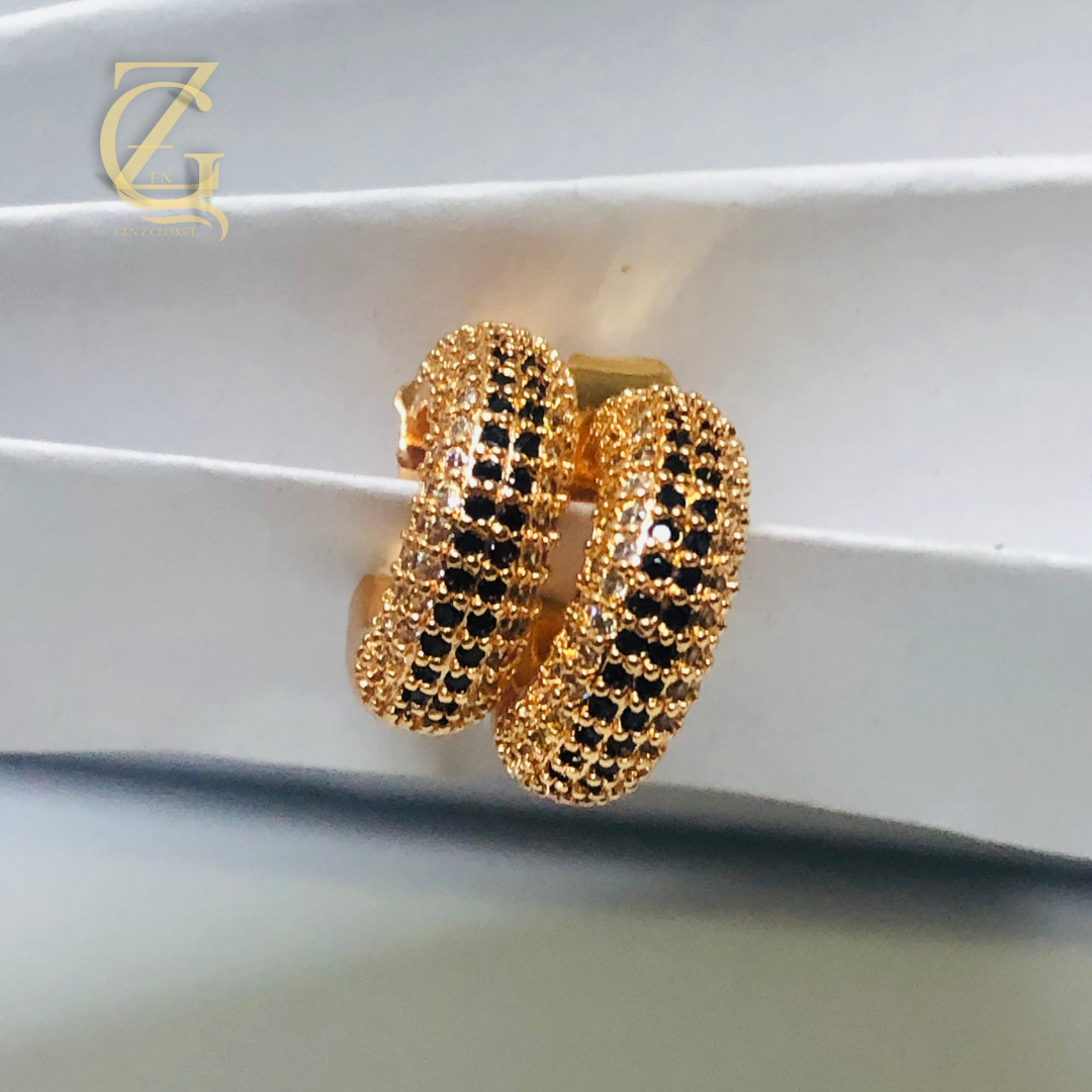 86 Add a touch of elegant sparkle to any look with these Gold Plated Ruby Crystal Huggi Hoop Earrings. Featuring deep ruby‑colored crystals set in gleaming gold‑plated hoops, they hug your ears comfortably while radiating rich, timeless charm — perfect for both everyday glam and special occasions.