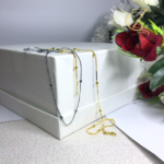 Minimalist silver stainless steel snake chain locket with bead accents on a white background, anti-tarnish jewelry by GenZcloxet Pakistan.