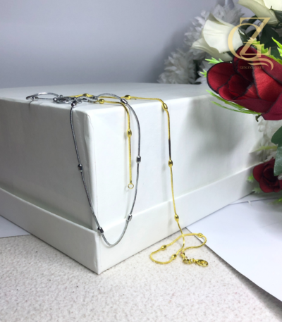 Minimalist silver stainless steel snake chain locket with bead accents on a white background, anti-tarnish jewelry by GenZcloxet Pakistan.