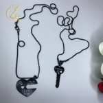 Pair of matching black couple necklaces featuring a heart and key pendant with I LOVE YOU engraving.