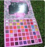 63-color eyeshadow palette featuring a variety of blue, green, and purple matte and shimmer shades.
